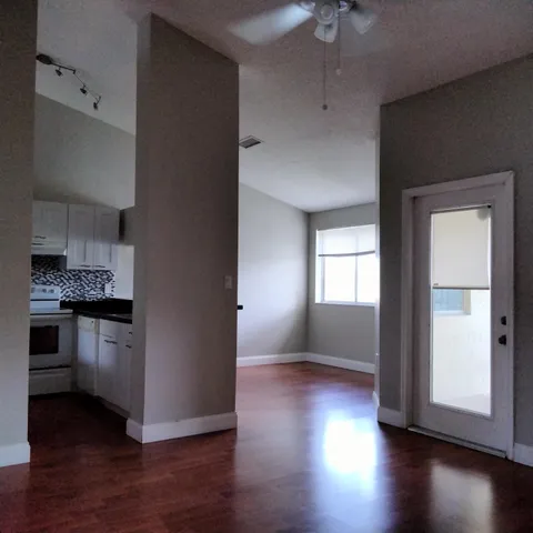 a kitchen with hard wood floors and white appliances