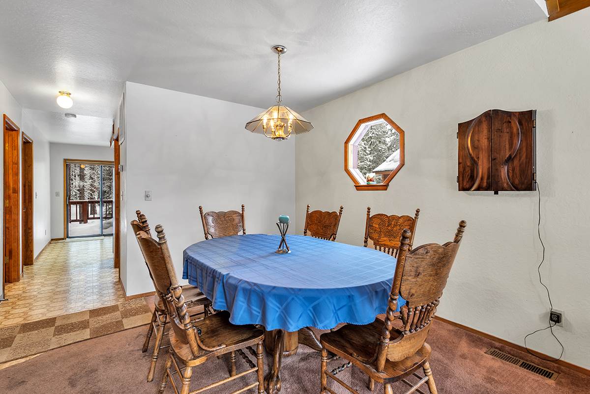 11780 Oslo Drive Truckee, CA 96161 - Photo 6 of 21 a view of a dining room with furniture wooden floor and a chandelier