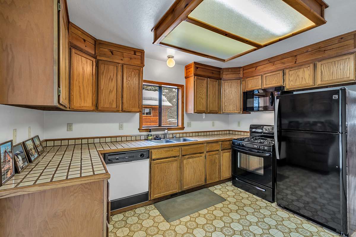11780 Oslo Drive Truckee, CA 96161 - Photo 8 of 21 a kitchen with stainless steel appliances granite countertop a sink stove and refrigerator