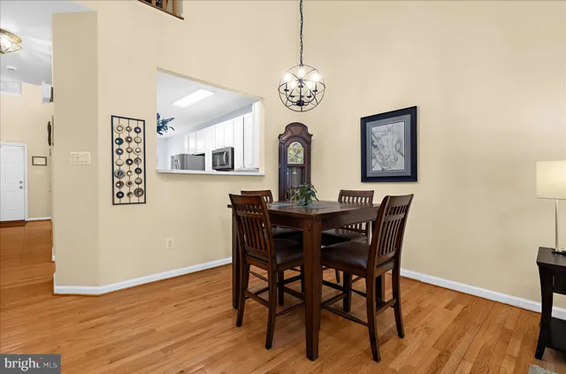 a living room with furniture a flat screen tv and a floor to ceiling window