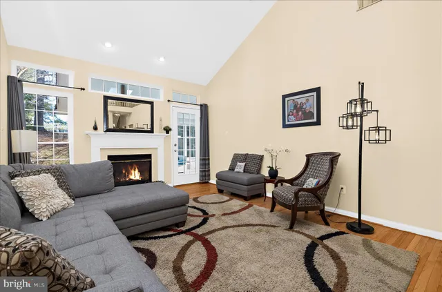 a living room with a flat screen tv and a refrigerator