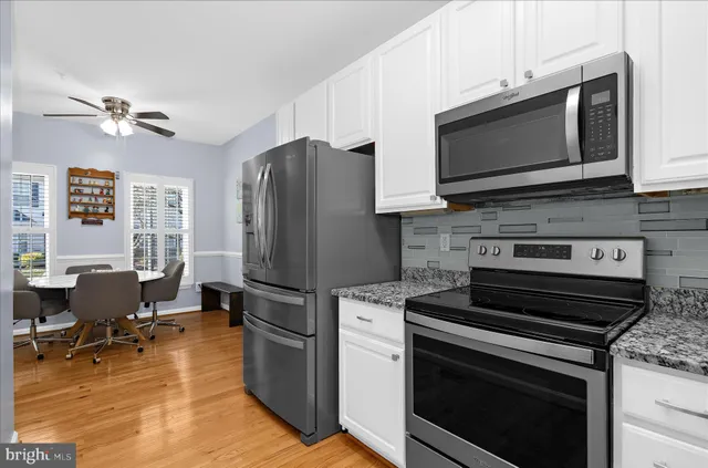 a view of a dining room with furniture wooden floor and a chandelier