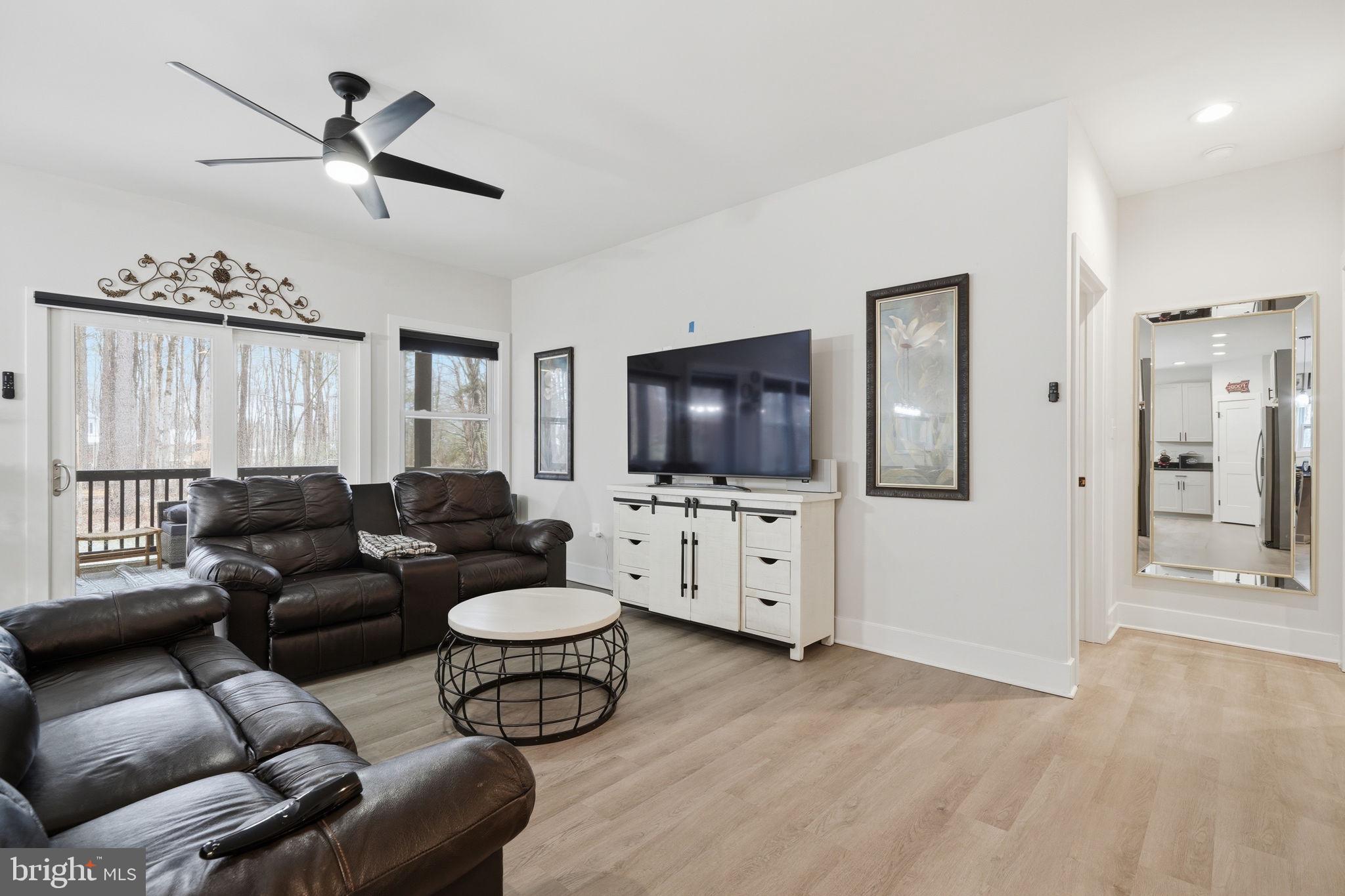 107 Pinewood Lane Colonial Beach, VA 22443 - Photo 11 of 25 a living room with furniture and a flat screen tv