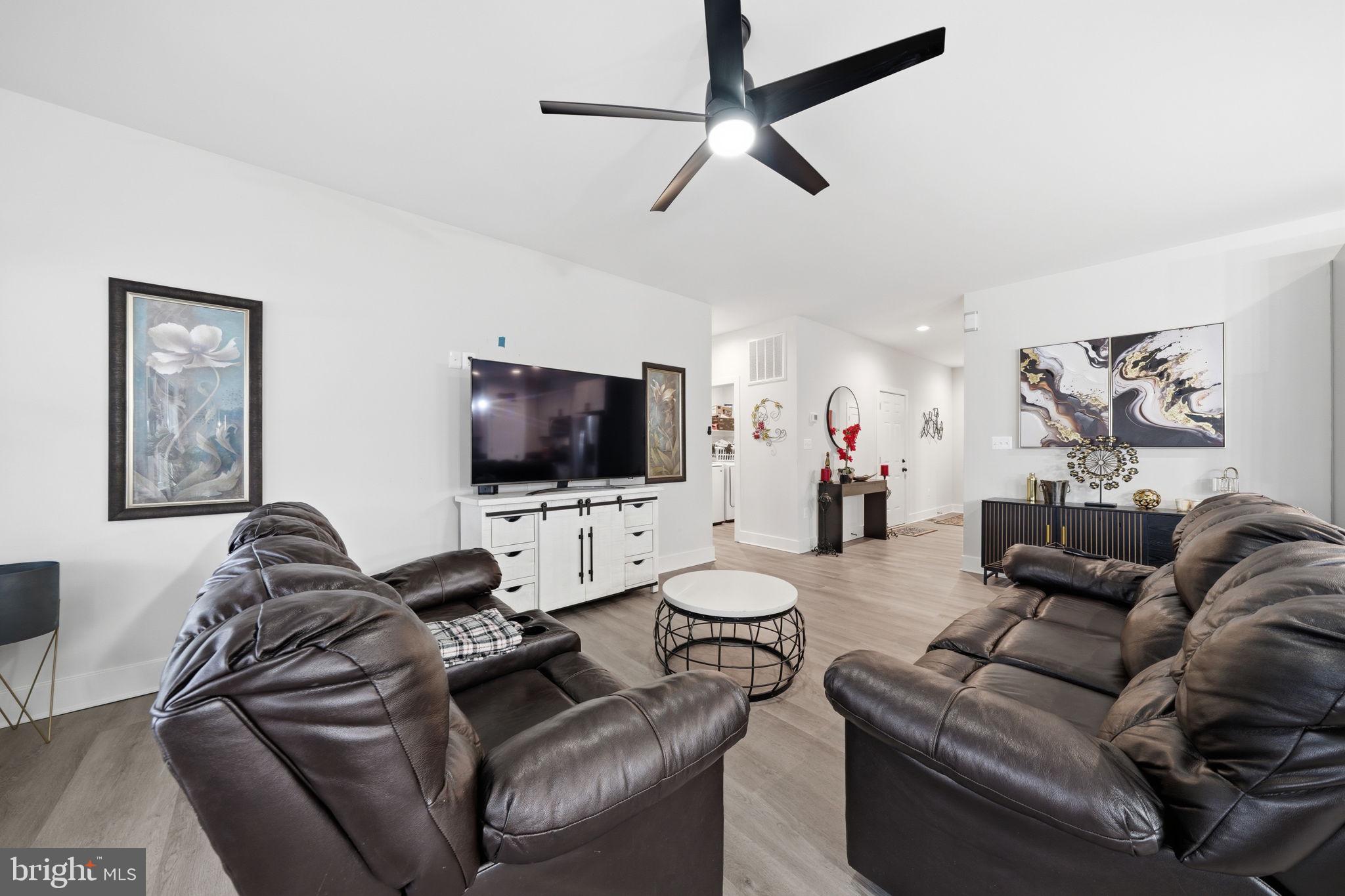 107 Pinewood Lane Colonial Beach, VA 22443 - Photo 12 of 25 a living room with furniture and a flat screen tv