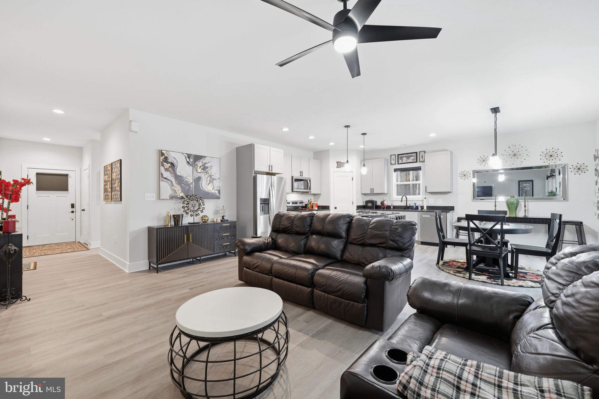 107 Pinewood Lane Colonial Beach, VA 22443 - Photo 13 of 25 a living room with furniture and a wooden floor