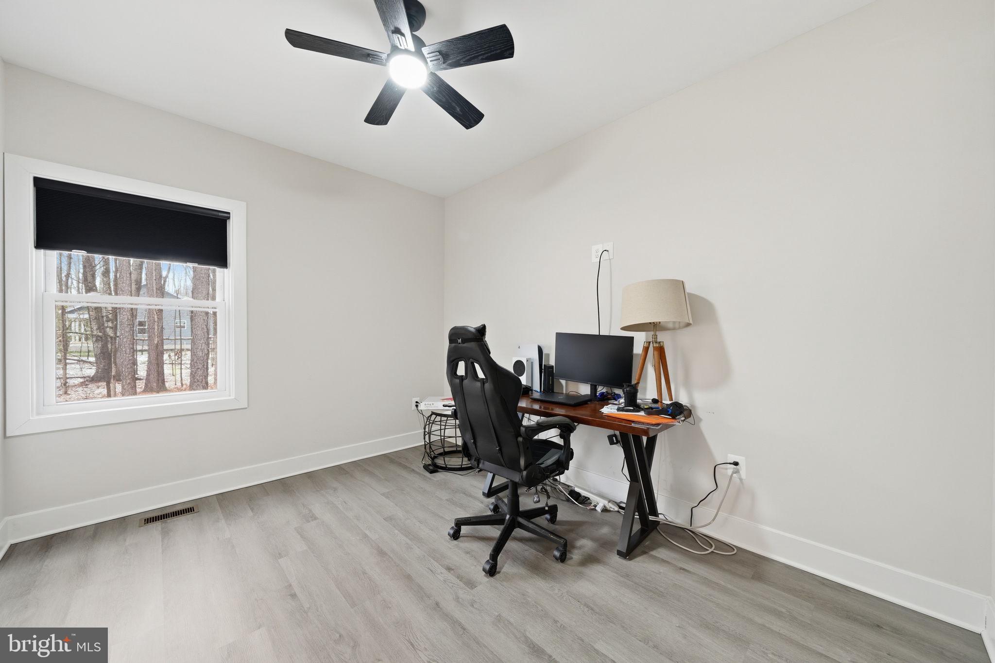 107 Pinewood Lane Colonial Beach, VA 22443 - Photo 15 of 25 a view of a workspace with furniture and a window