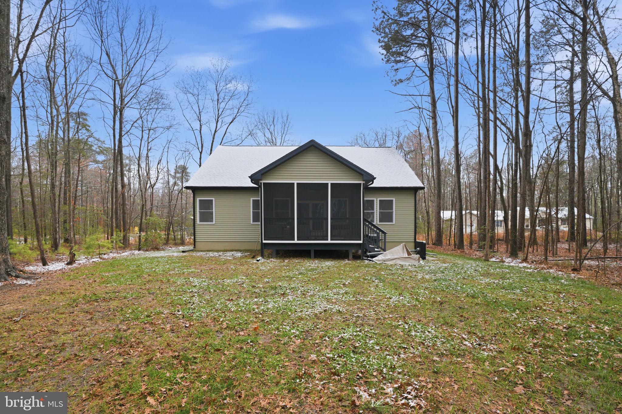 107 Pinewood Lane Colonial Beach, VA 22443 - Photo 24 of 25 a house with trees in the background