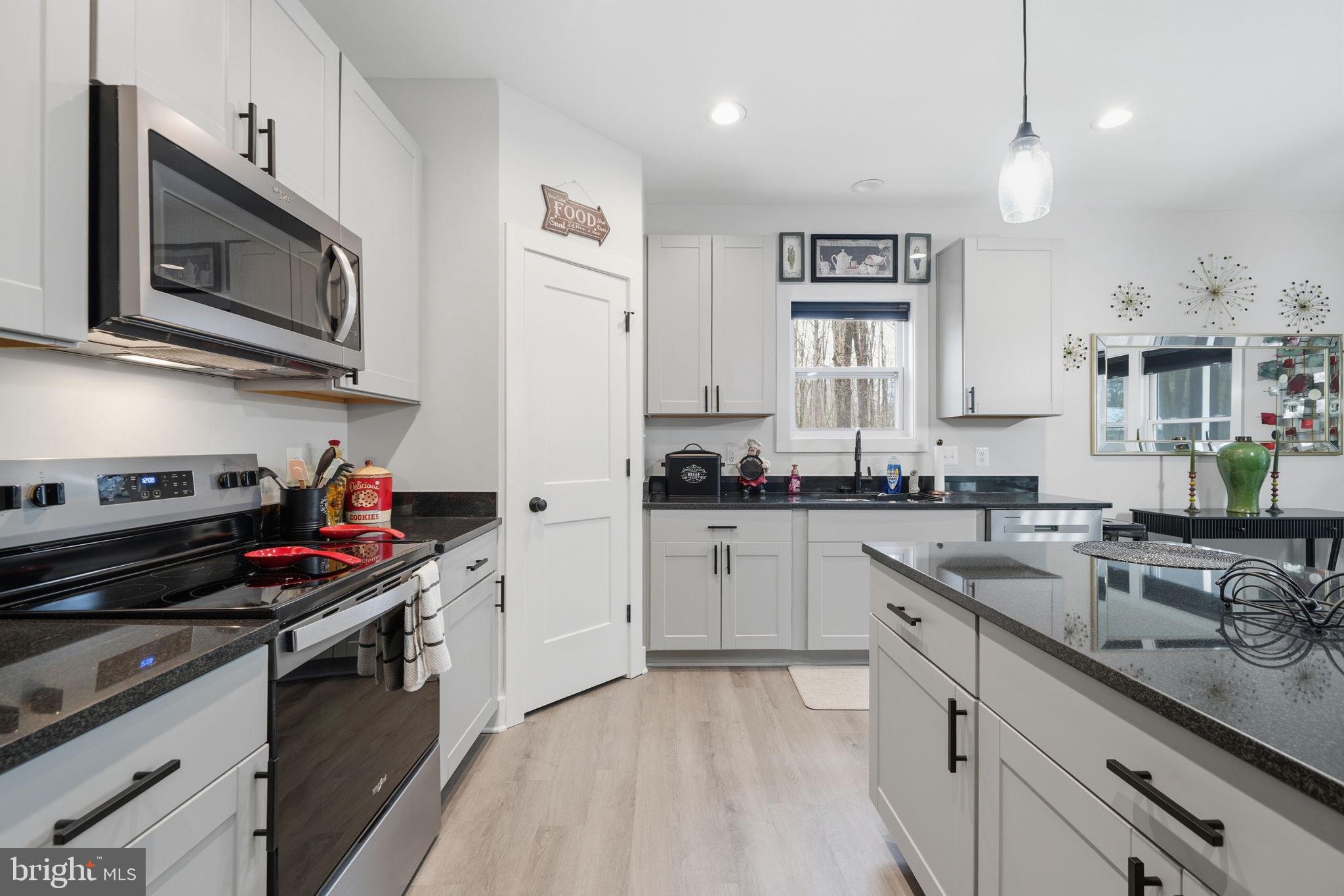 107 Pinewood Lane Colonial Beach, VA 22443 - Photo 5 of 25 a kitchen with stainless steel appliances granite countertop a stove and a sink