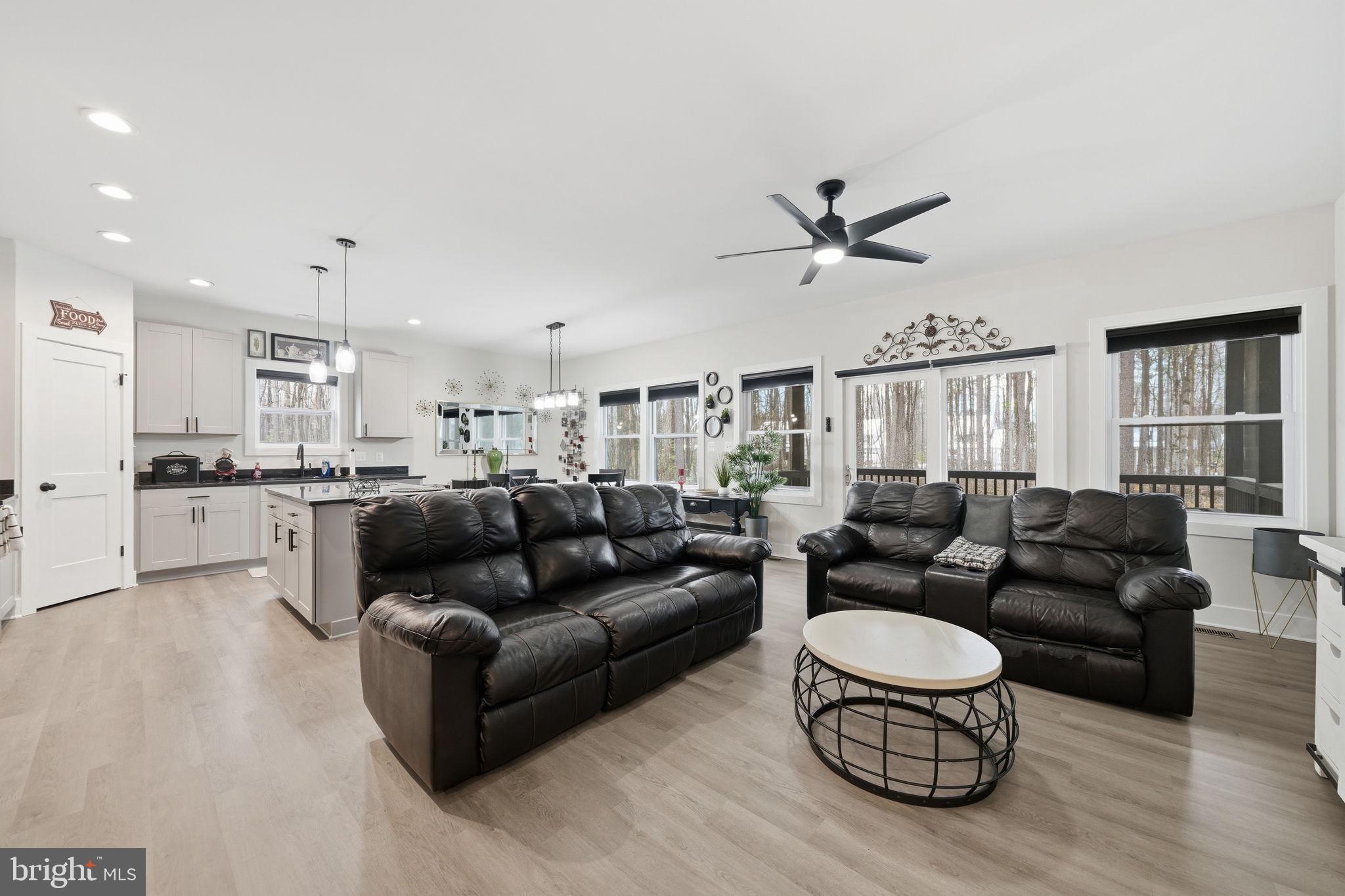 107 Pinewood Lane Colonial Beach, VA 22443 - Photo 10 of 25 a living room with furniture kitchen and a table