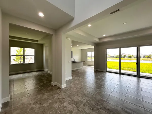 an empty room with large windows
