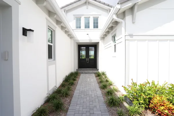 a front view of a house with a garden