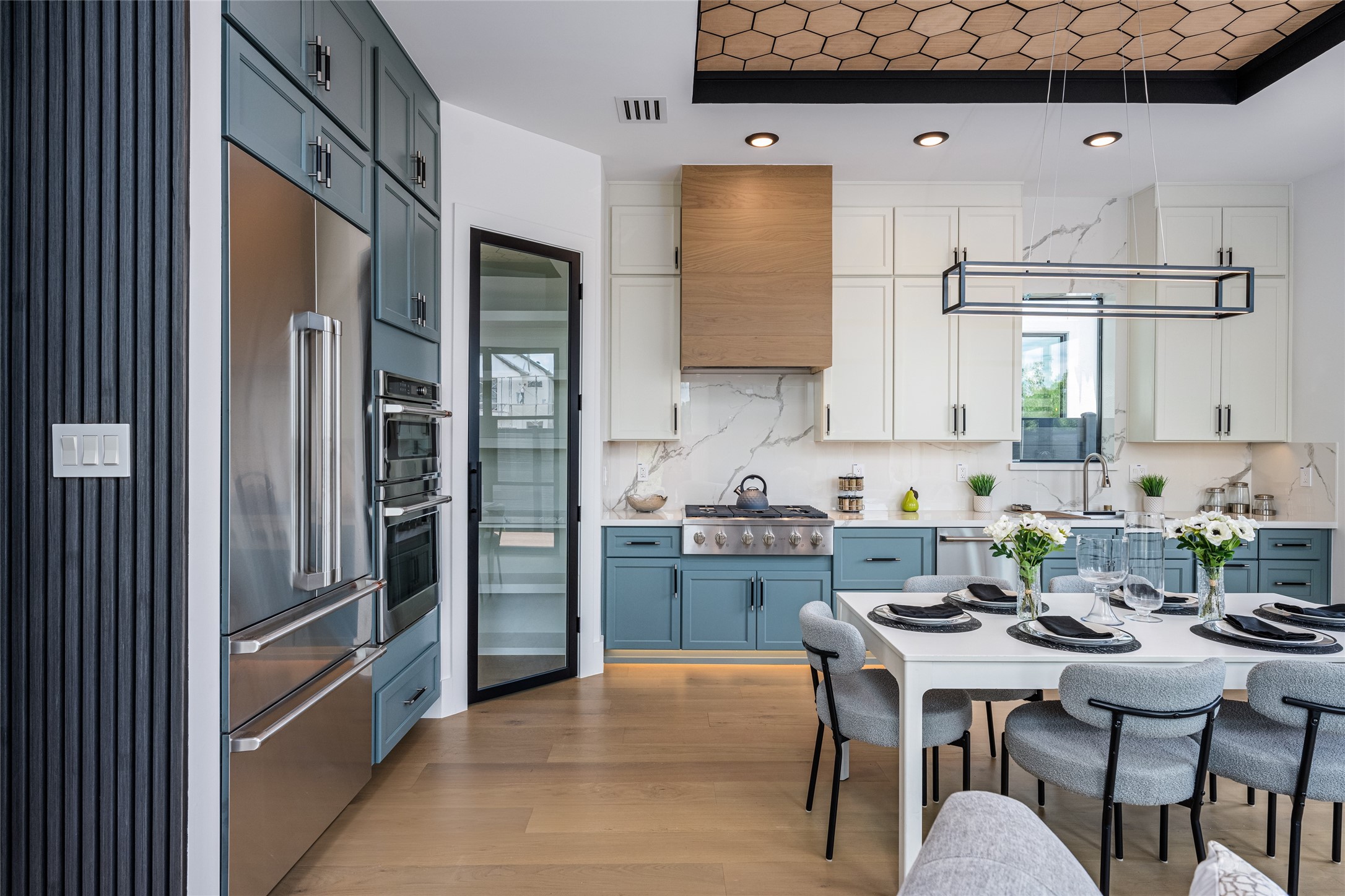 623 Rolling Oaks Stafford, TX 77477 - Photo 17 of 50 The kitchen/dining area features bespoke chandeliers and a tray ceiling with wood inlays, offering a truly refined dining experience