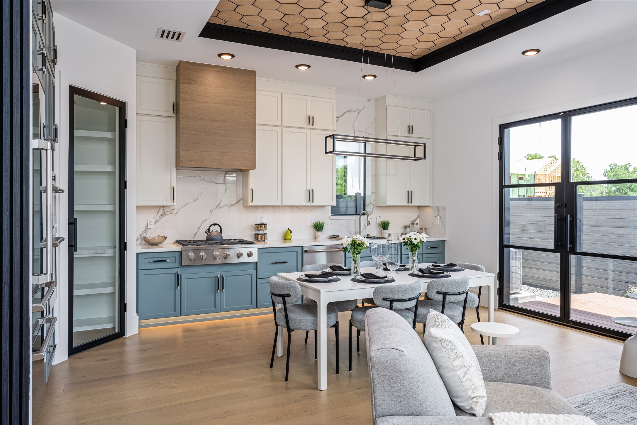 623 Rolling Oaks Stafford, TX 77477 - Photo 18 of 50 Enjoy two-tone custom cabinetry in designer hues, luxurious porcelain countertops, and full-height backsplash. A glass-framed pantry with interior countertop and GE Café appliances complete this dream kitchen