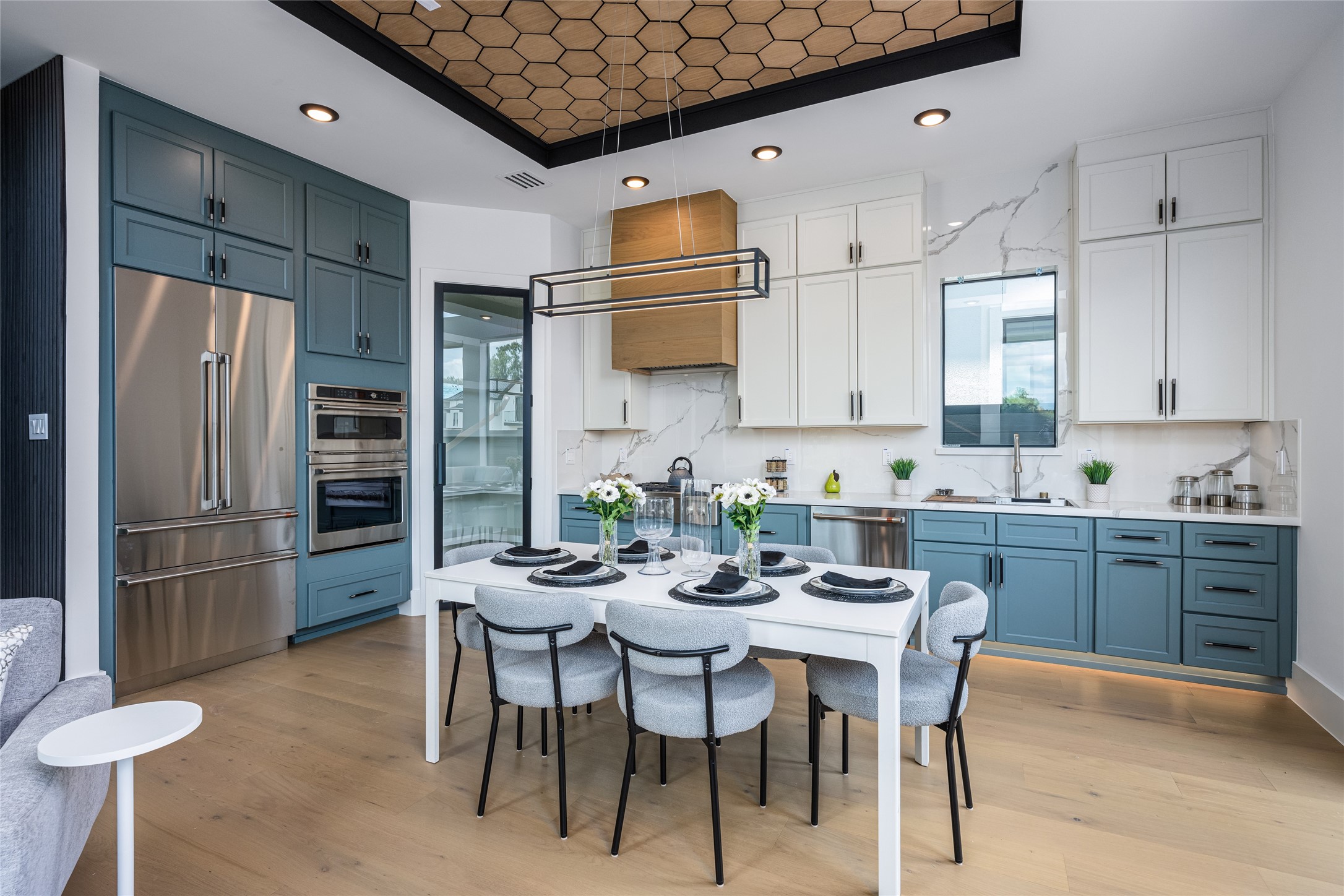 623 Rolling Oaks Stafford, TX 77477 - Photo 20 of 50 Enjoy two-tone custom cabinetry in designer hues, luxurious porcelain countertops, and full-height backsplash. A glass-framed pantry with interior countertop and GE Café appliances complete this dream kitchen