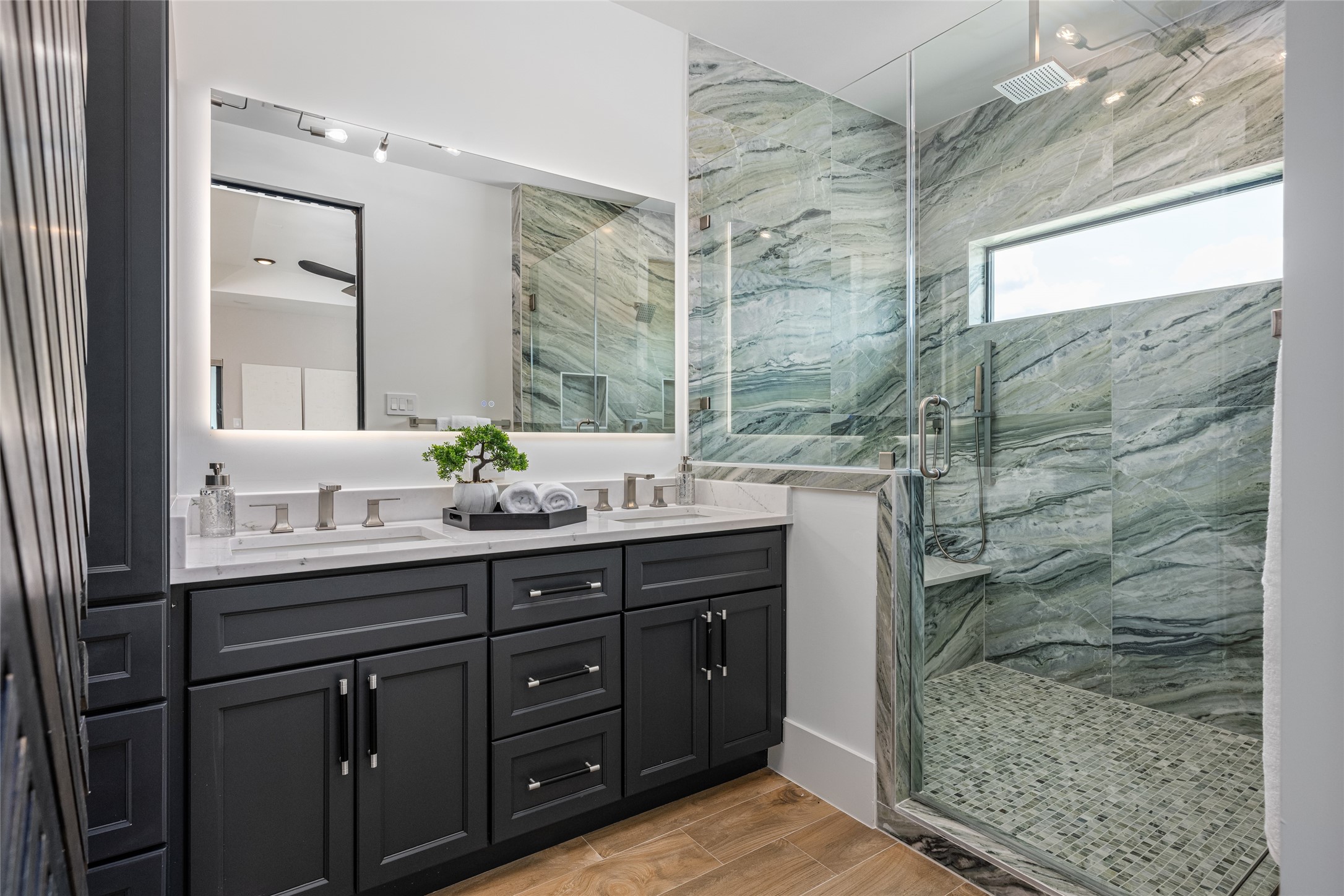 623 Rolling Oaks Stafford, TX 77477 - Photo 37 of 50 An ultra-luxurious primary bath features dual illuminated mirrors, designer cabinetry, quartz counters, and elegant fixtures