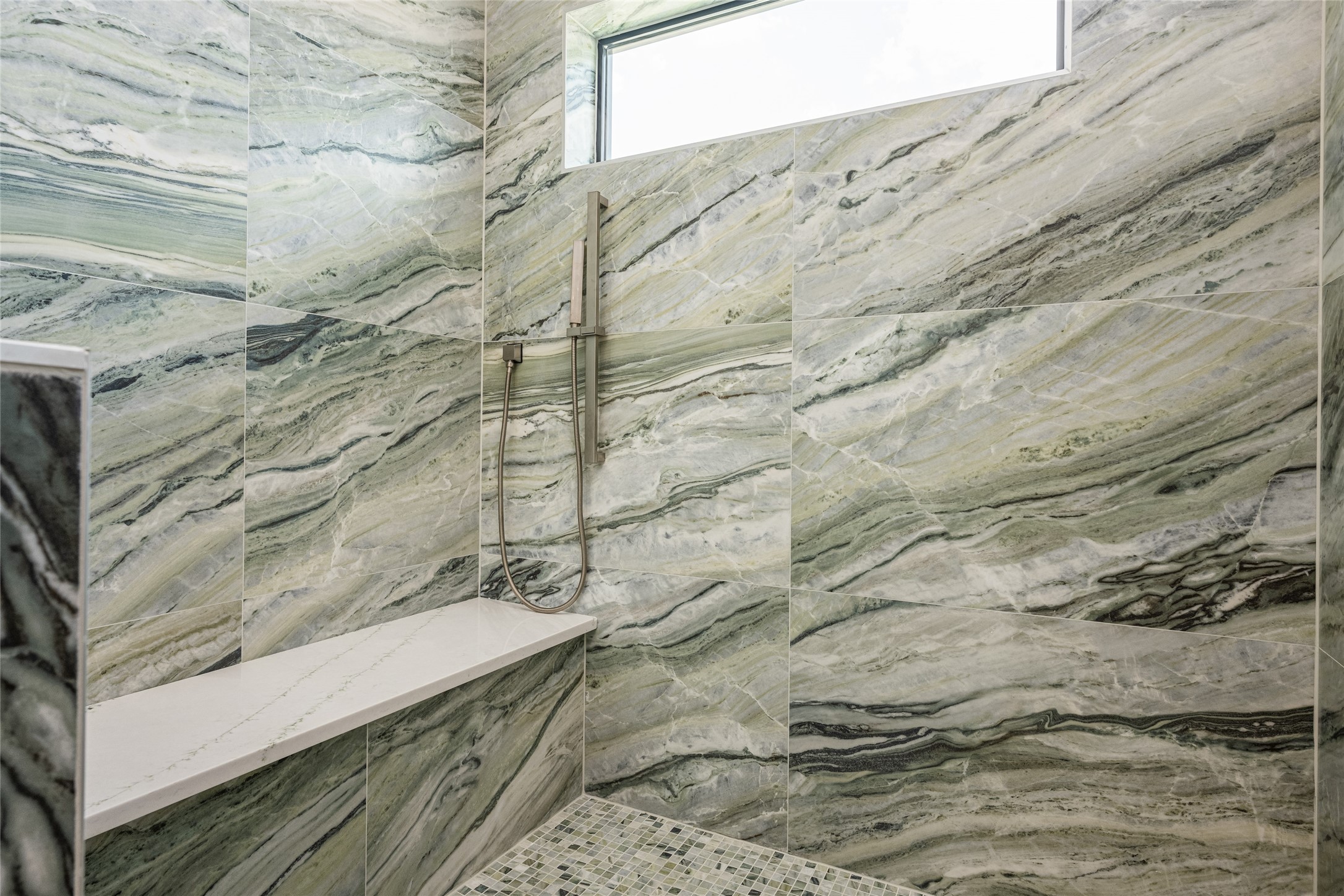 623 Rolling Oaks Stafford, TX 77477 - Photo 42 of 50 The shower suite boasts three heads—rainfall, wall-mounted, and handheld—surrounded by porcelain tile to the ceiling and framed by a bright window