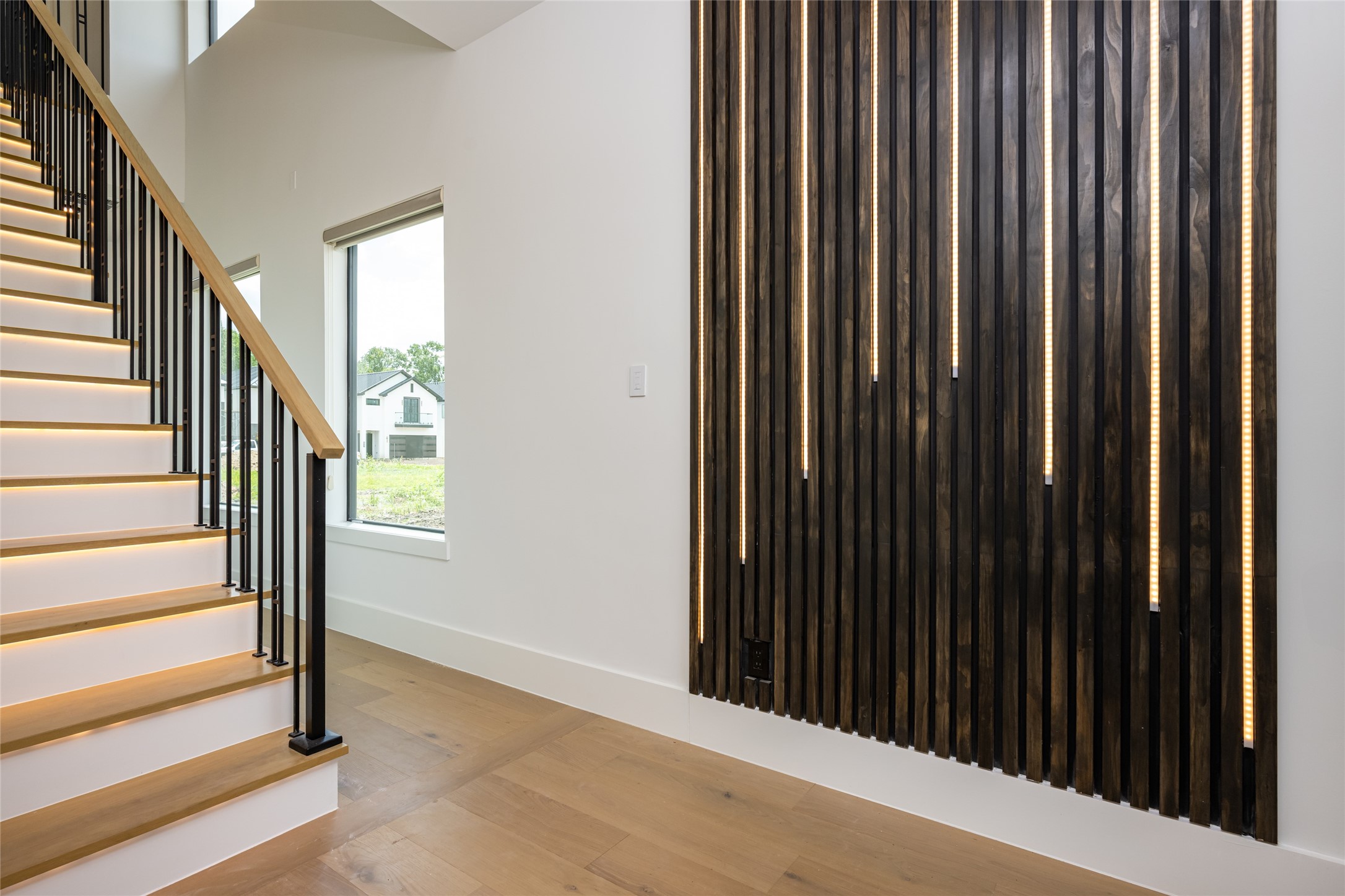 623 Rolling Oaks Stafford, TX 77477 - Photo 6 of 50 A sculptural staircase showcases white oak treads and sleek, modern iron spindles—both functional and visually captivating