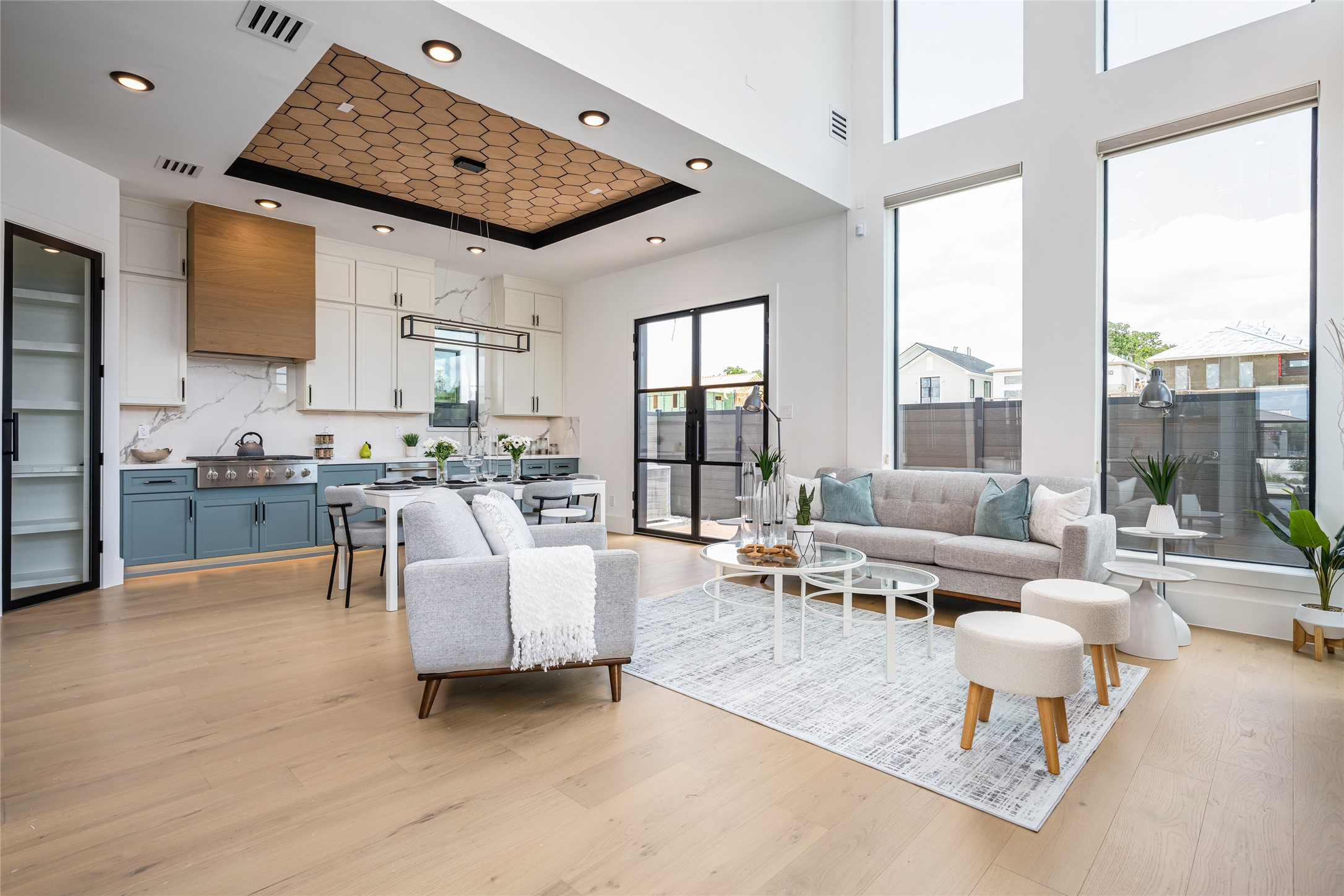 623 Rolling Oaks Stafford, TX 77477 - Photo 8 of 50 Soaring ceilings in the family room paired with a wall of 8-foot picture windows flood the space with light, delivering a showstopping “wow” factor