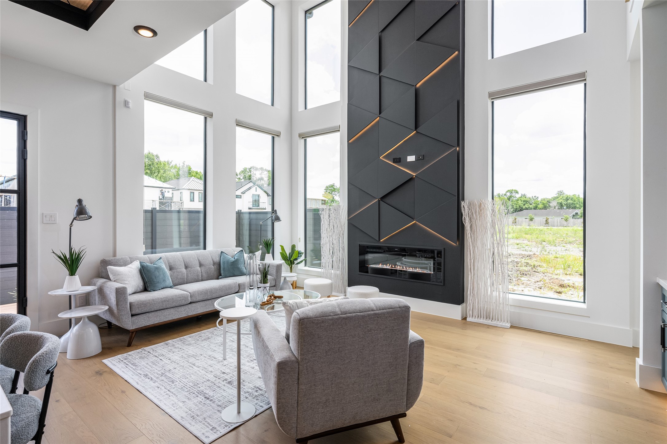 623 Rolling Oaks Stafford, TX 77477 - Photo 9 of 50 A sleek electric fireplace wrapped in an LED-lit feature wall creates an eye-catching focal point and elevates the living experience