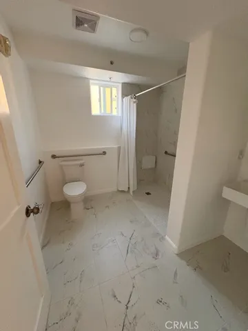 a bathroom with a sink a mirror and shower