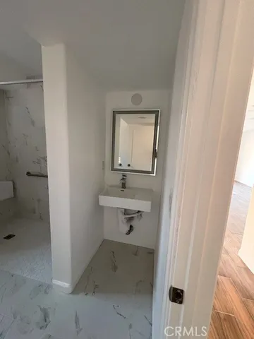 a bathroom with a sink mirror vanity and toilet