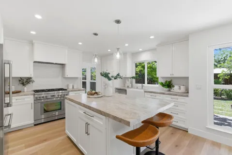 a kitchen with a stove a sink and a refrigerator