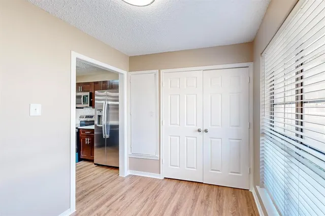 an empty room with wooden floor and closet