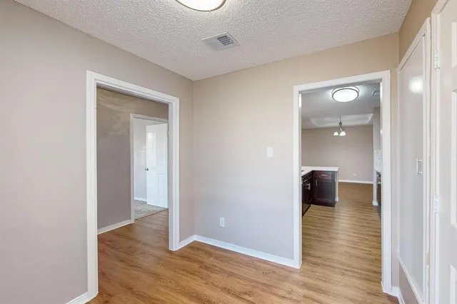 a view of a room with wooden floor