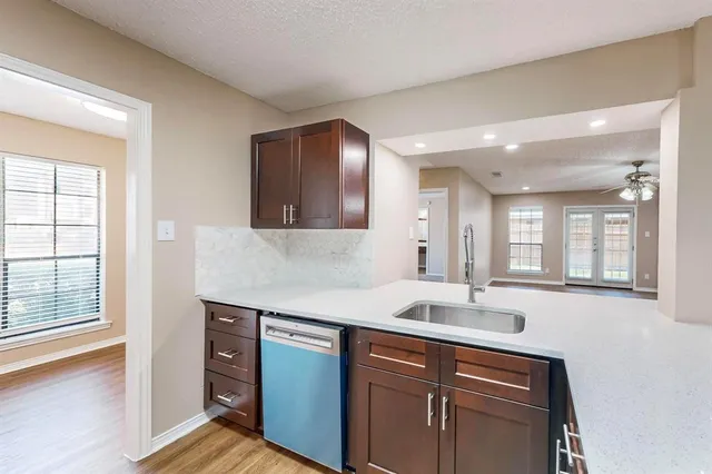 a kitchen with a sink cabinets and window