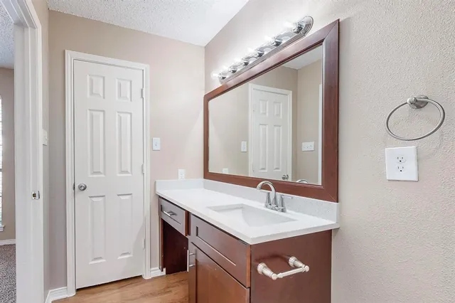 a bathroom with a sink a toilet and a large mirror