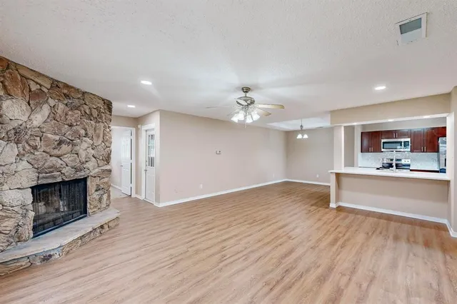 a view of an empty room and fire place