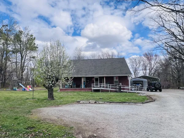 a front view of house with yard and green space