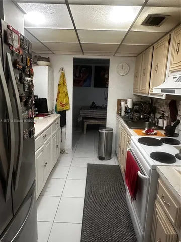 a kitchen with a stove and a refrigerator
