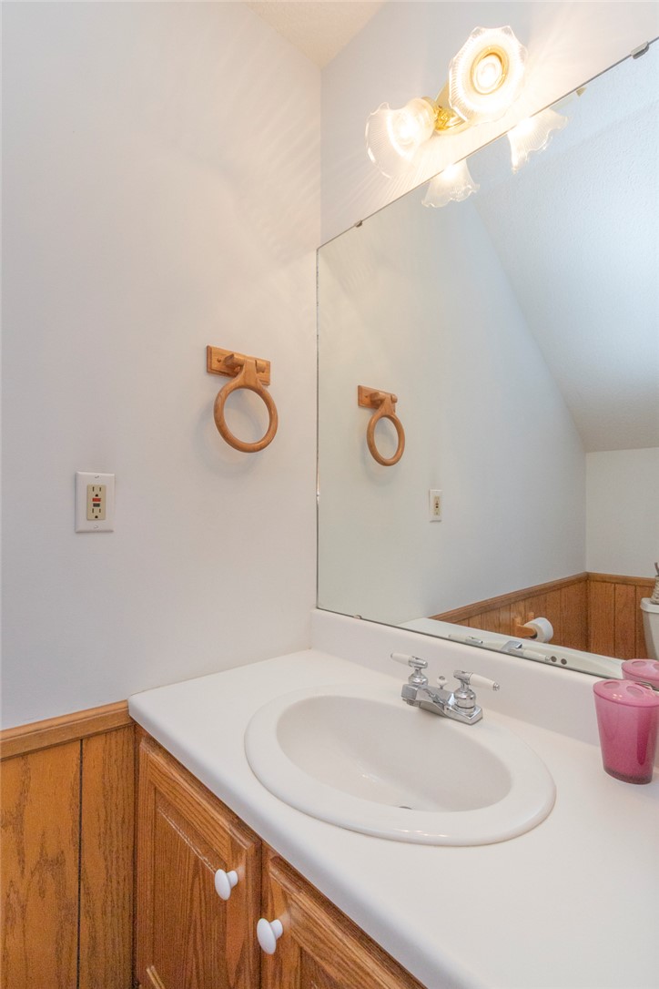 202 Plantation Point Anderson, SC 29625 - Photo 36 of 48 A well-lit vanity with a white countertop and natural wood paneling offers functional style.