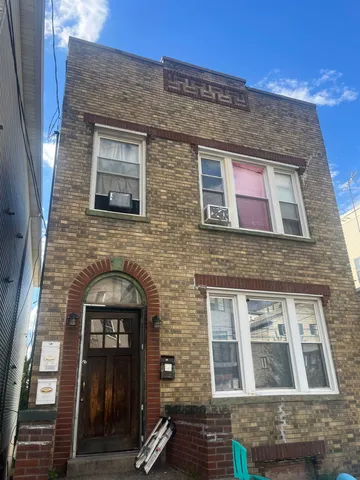 a car parked in front of a brick building