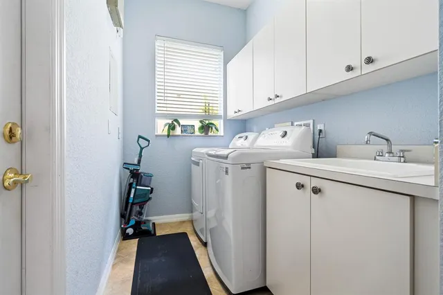 a kitchen with a refrigerator and a stove top oven