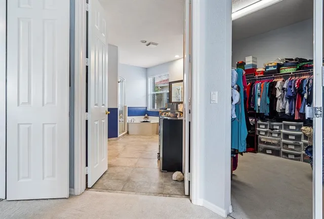 a white toilet sitting next to a bath tub