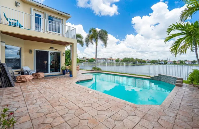 a view of a patio with swimming pool table and chairs