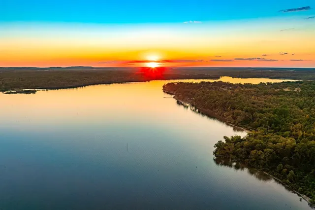 a view of lake with sunset