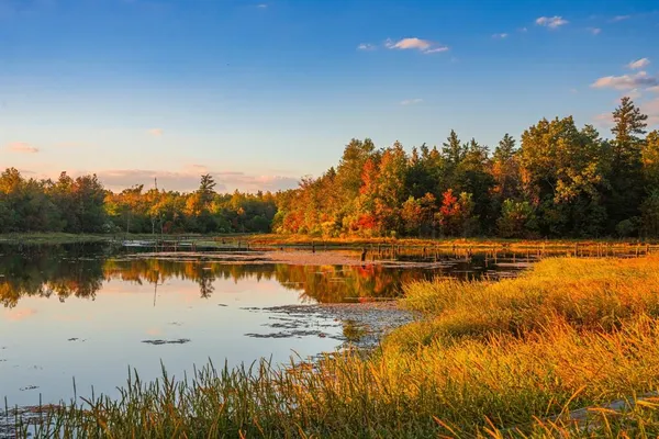 a view of a lake with a table and chairs