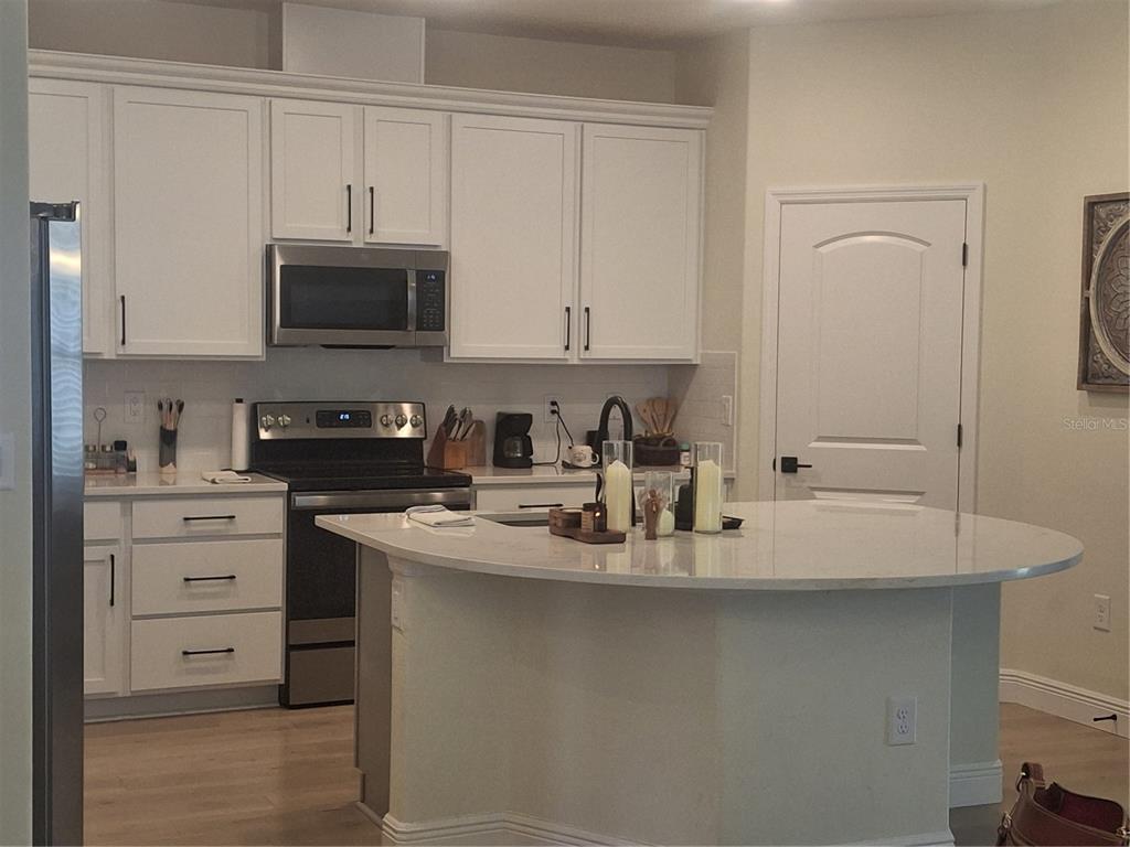 12618 Vander Way New Port Richey, FL 34654 - Photo 4 of 22 a kitchen with stainless steel appliances granite countertop a sink stove and microwave