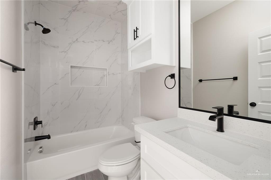905 Crestview Street Weslaco, TX 78596 - Photo 7 of 10 a bathroom with a sink a toilet and a bathtub