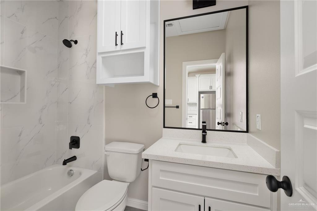 905 Crestview Street Weslaco, TX 78596 - Photo 9 of 10 a bathroom with a sink a toilet and shower