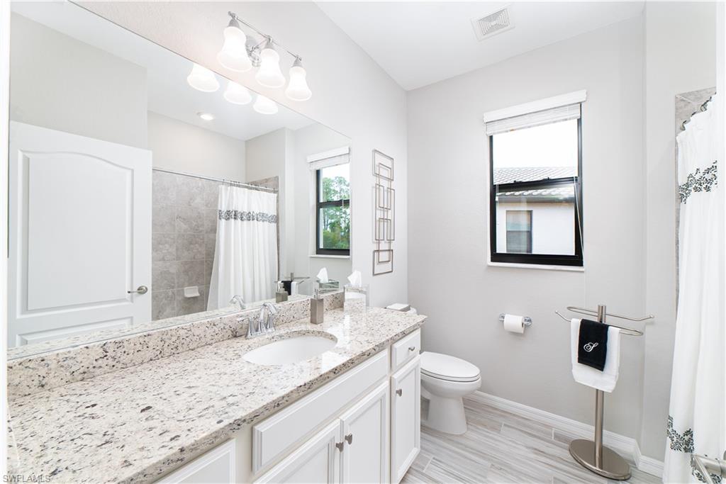 1654 Marton Court Naples, FL 34113 - Photo 10 of 29 Guest bath with granite counters and tub/shower combination.