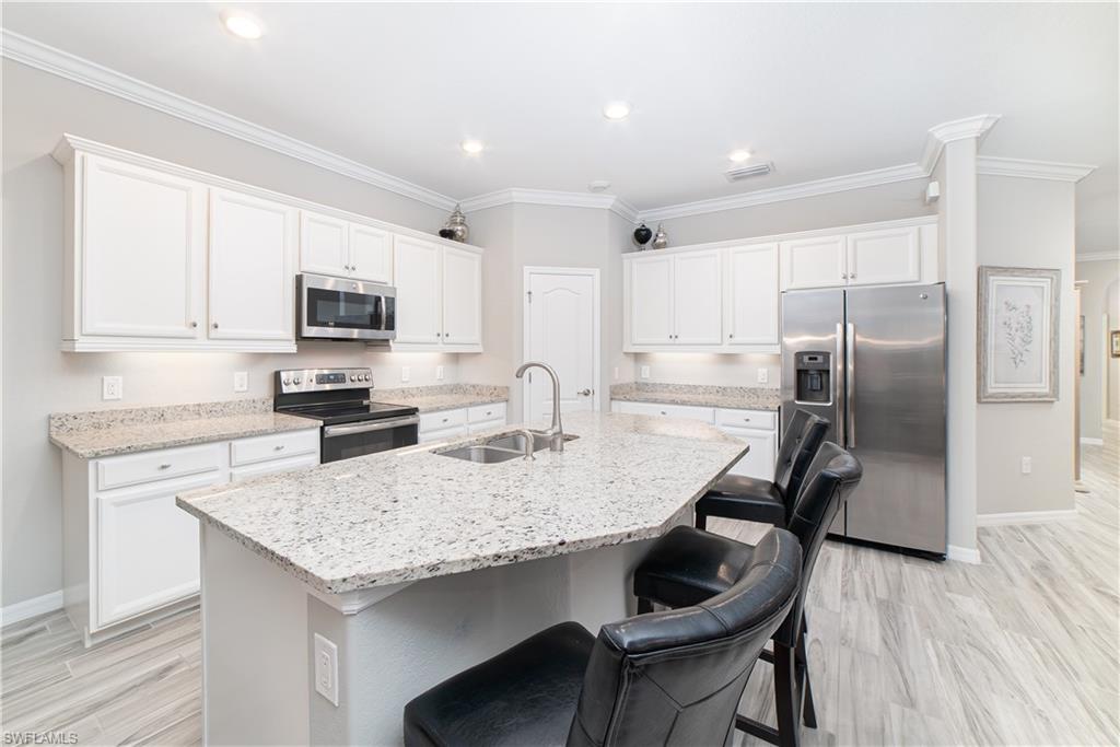 1654 Marton Court Naples, FL 34113 - Photo 5 of 29 Casual dining at the island for a meal or snack.