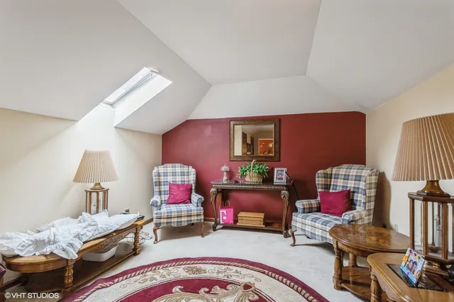 a bedroom with furniture and a lamp