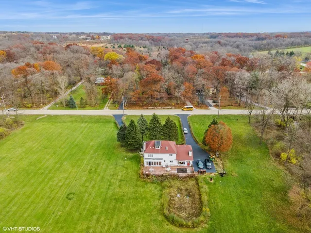 an aerial view of a house with a yard