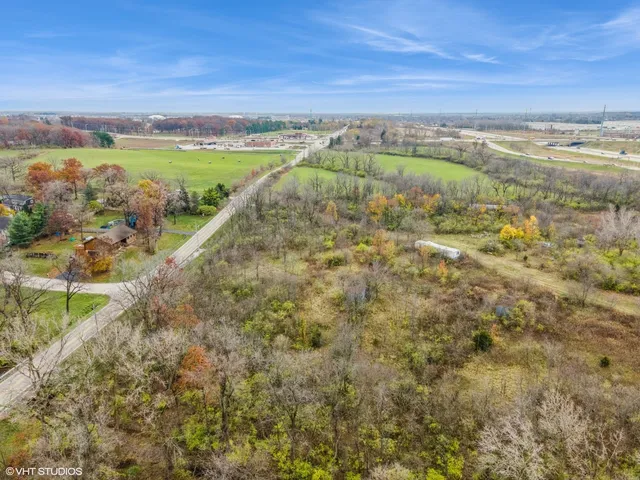 a view of a green field with an ocean view