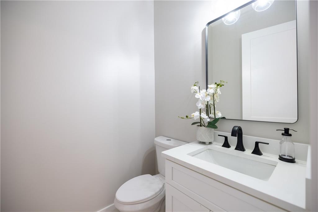 982 Wildberry Court Jefferson, GA 30549 - Photo 12 of 64 a bathroom with a sink a toilet and a mirror