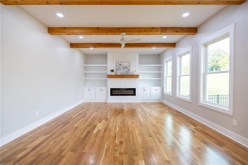 982 Wildberry Court Jefferson, GA 30549 - Photo 14 of 64 a view of empty room with a fireplace and wooden floor